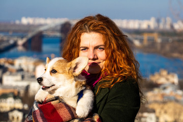 young woman with welsh corgi puppy