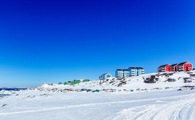 Fototapeta na wymiar Colorful Inuit houses of Nuuk city with mountains in the background, Greenland