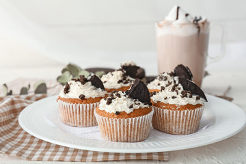 Plate with tasty muffins on table