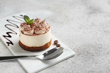 Tasty tiramisu on grey table