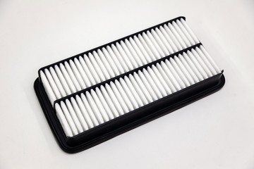Spare part for car engine air filter for cleaning dust and dirt on a white isolated background. Maintenance and oil change in auto service industry.