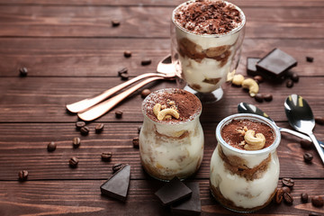 Tasty tiramisu on wooden table