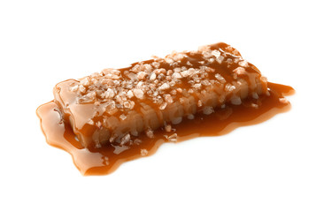 Tasty salty caramel candy on white background