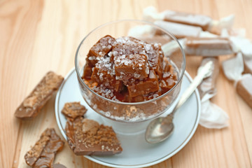 Tasty salted caramel on wooden table