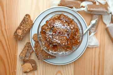 Tasty salted caramel on wooden table