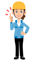 人差し指をたてる建築現場作業員の女性　青い作業着