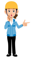 警告する建築現場作業員の女性　青い作業着