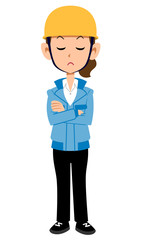 腕組みして考える建築現場作業員の女性　青い作業着