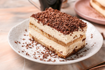 Plate with tasty tiramisu on table