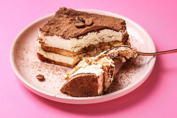 Plate with tasty tiramisu on color background