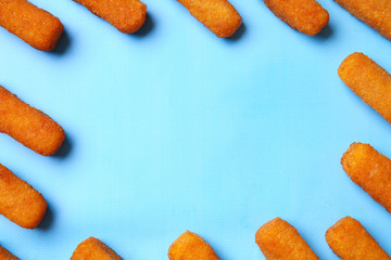 Frame made of tasty mozzarella sticks on color background
