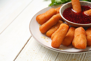 Plate with tasty mozzarella sticks and jam on white table