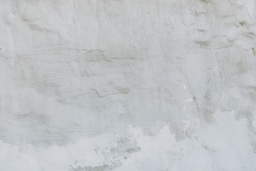 Textured wall of the old house. The texture of old cracked concrete with paint.