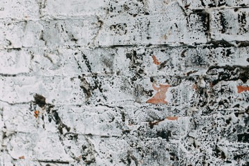 Textured wall of the old house. Texture of old brick wall with paint.