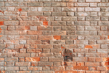 Textured wall of the old house. Texture of old brick wall with paint.