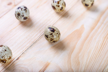 Quail eggs on wooden background.