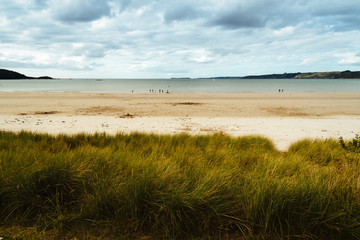 Tranquil beach against cloudy sky in Brittany