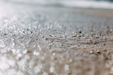  Blurred background and bokeh. The texture of the mud on the ground with a glare.