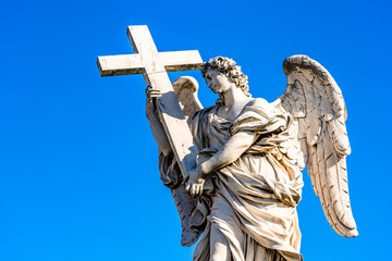 Statue of an Angel with the Cross on Sant'Angelo Bridge in Rome, Italy
