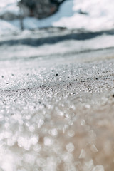  Blurred background and bokeh. The texture of the mud on the ground with a glare.