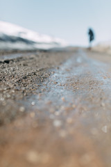  Blurred background and bokeh. The texture of the mud on the ground with a glare.