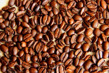 lots of coffee beans, close-up, background. coffee beans after roasting cool on the table, selective focus. coffee beans after roasting