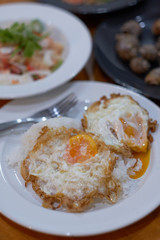 Close up Rice with two fried egg on the white plate