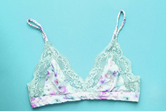 Beautiful multicolor sexy bra on blue background. Romantic lingerie.Top view.