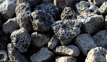 Stones on the edge of the asphalt road