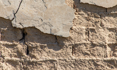 Old clay bricks wall as background