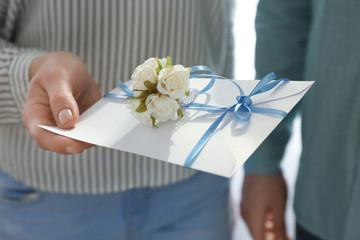 Couple with wedding invitation, closeup