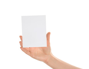 Fototapeta premium Female hand with blank invitation card on white background