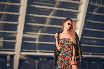 beautiful sexy woman in a short skirt in glases walking in the city