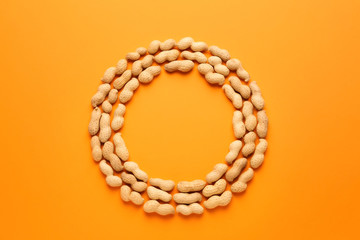 Obraz premium Frame made of tasty peanuts on color background