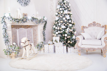 decorated Christmas tree, presents, an armchair, a fireplace