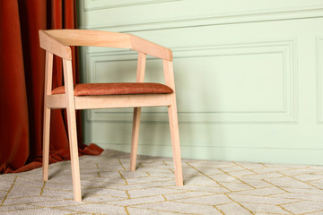 Modern wooden chair in interior of room