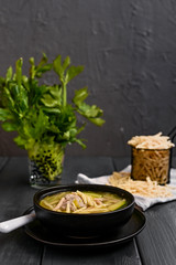 Dark photo of homemade pasta Trofie from Liguria . Italian healthy food concept with copy space. Soup with homemade pasta and meat.