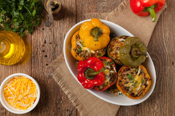 Colorful baked with cheese, stuffed peppers with rice and minced meat.