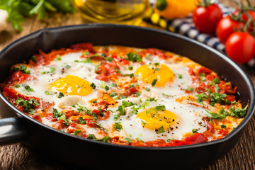 Shakshouka, dish of eggs poached in a sauce of tomatoes, chili peppers, onions