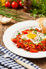 Shakshouka, dish of eggs poached in a sauce of tomatoes, chili peppers, onions