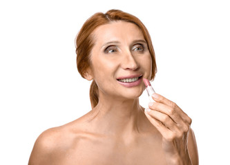 Mature woman with lipstick on white background