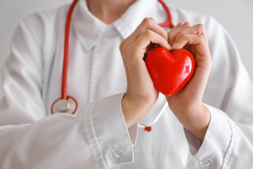 Cardiologist with red heart, closeup