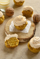 Carrot coconut cupcakes with walnut covered  cream cheese, vertical 