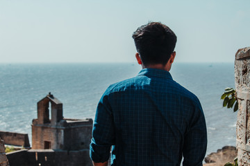 Fototapeta premium Man looking at destroyed ancient structure