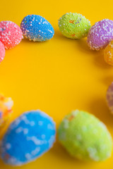 Fototapeta na wymiar Colorful easter eggs on yellow background