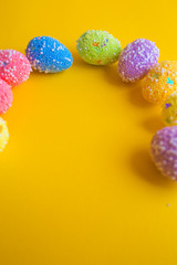 Colorful easter eggs on yellow background