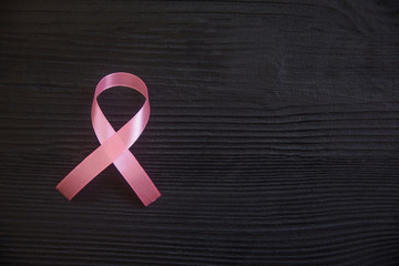 Pink ribbon symbol of breast cancer, cancer awareness month.