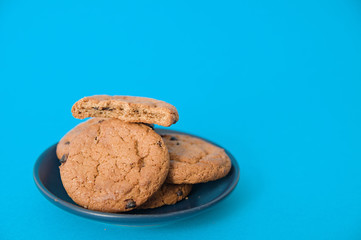 cookies on blue background. oatmeal cookie with pieces of chocolate