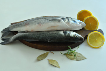fresh fish with lemon and Rosemary on wooden board. mediterranean diet . healthy food