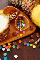 Milk pineapple drink on a wooden brown table. Summer ice cream and cocktails set. Top view